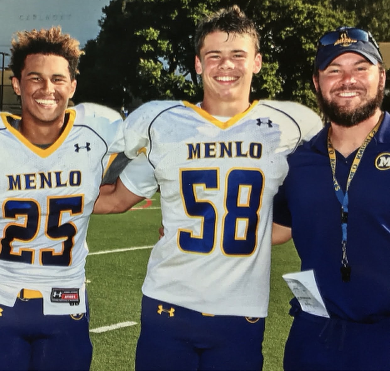 Coach Juarez with athletes on the field